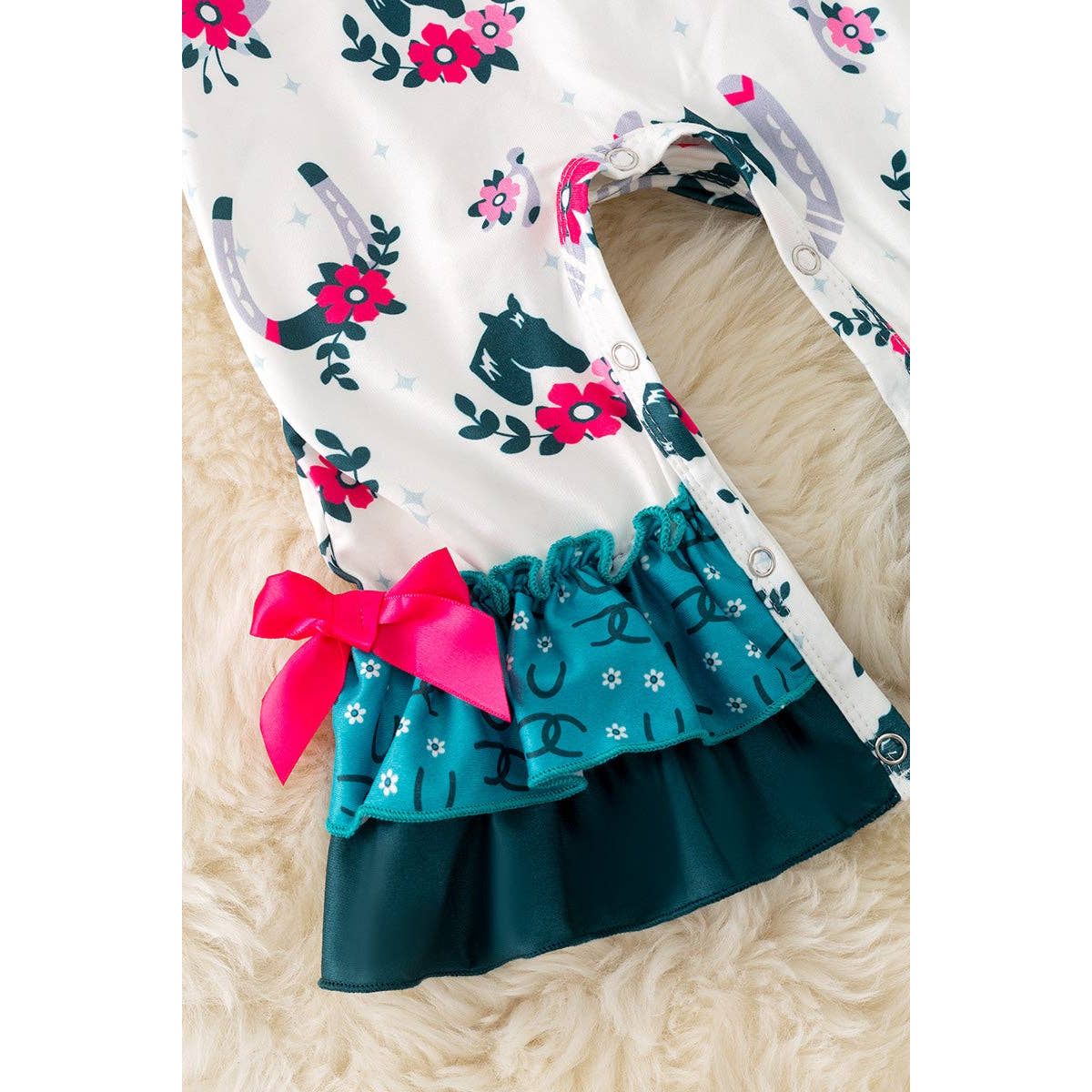 Horseshoe printed on white baby romper with ruffle hem. RPG52076