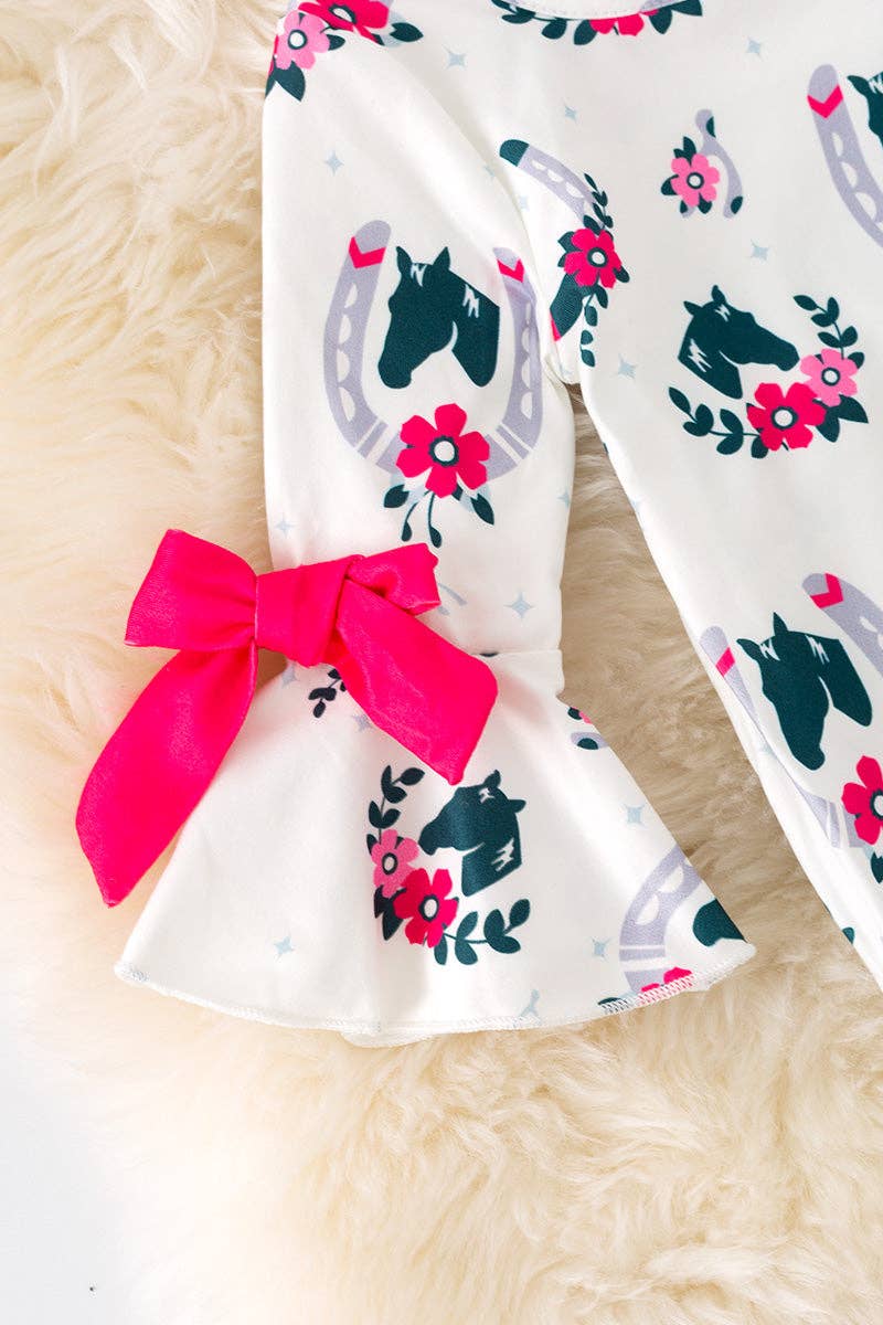 Horseshoe printed on white baby romper with ruffle hem. RPG52076